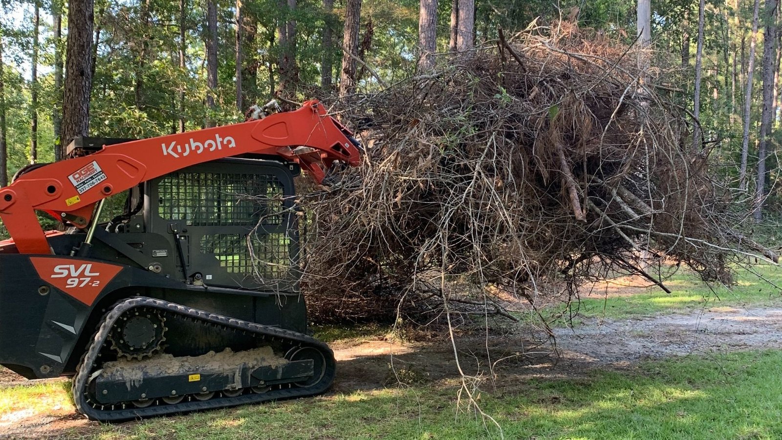 skid-steer cleaning up brush/debris